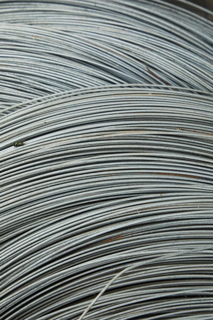 Abstract background of thin fragile white many wires placed chaotically in rows and lines